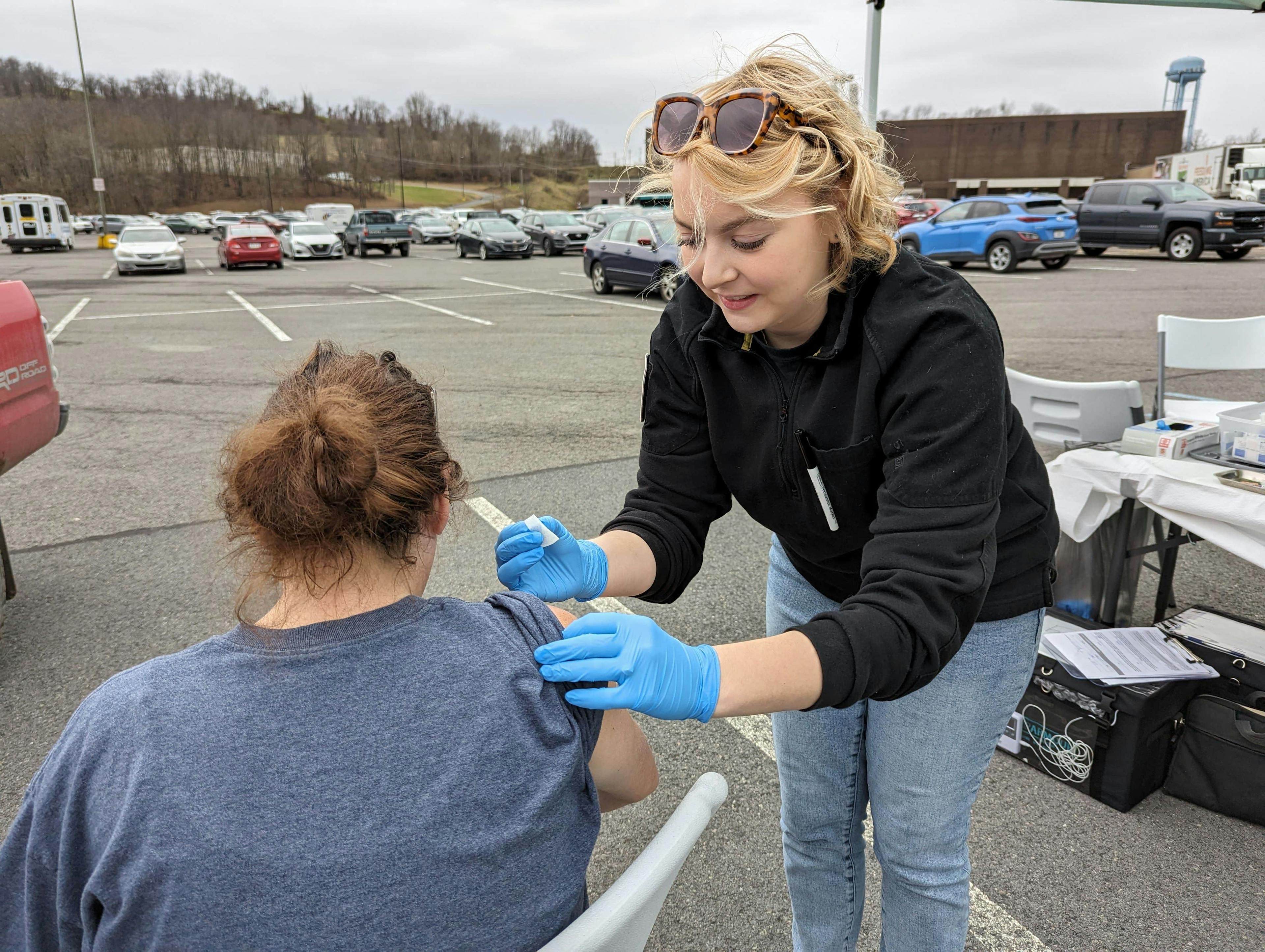 Chantry Kisling, R.N., gives a vaccine during an outreach event. 